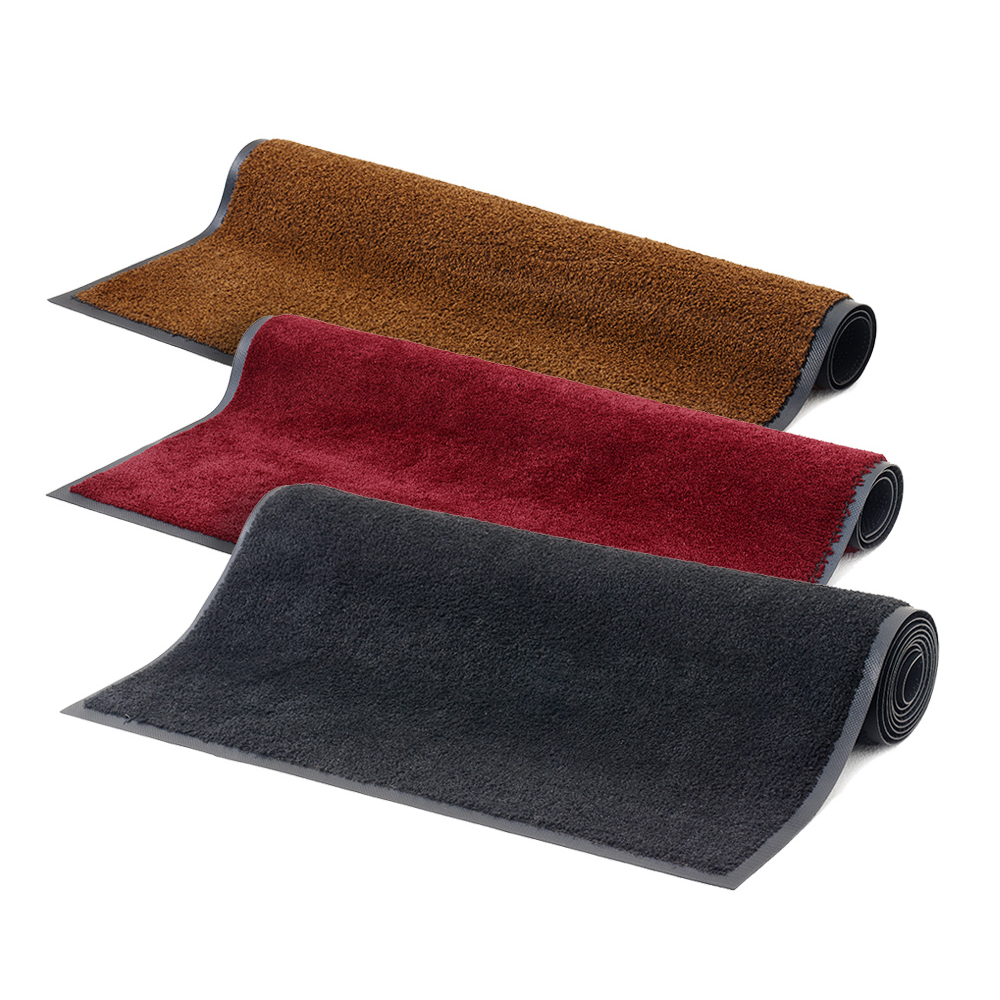 Three rolled Dempsey Uniform carpeted floor mats in multiple colors