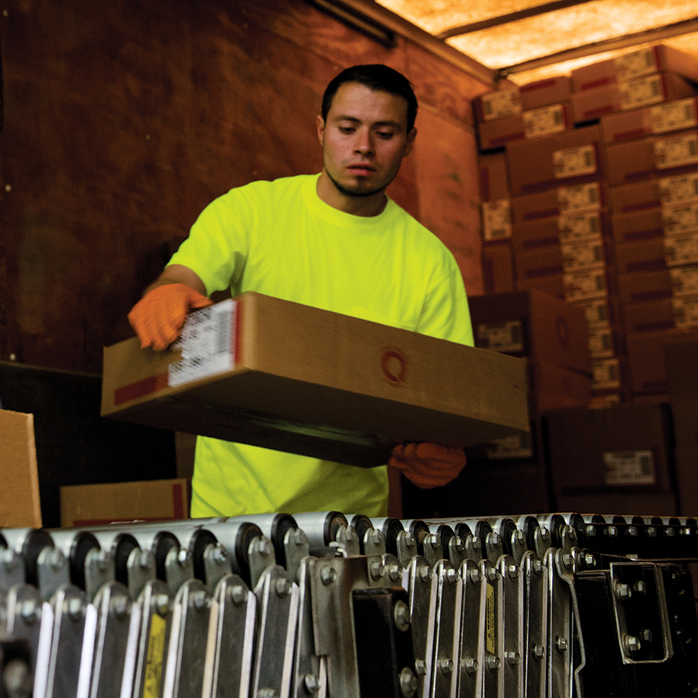 Loading dock worker wearing Dempsey Uniform high-visibility performance t-shirt