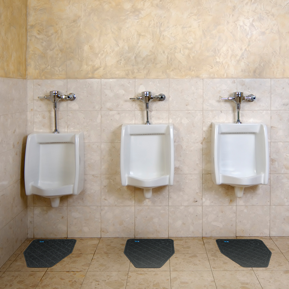 Dempsey Uniform urinal mats in a restroom