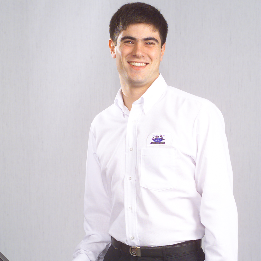 Man wearing white Dempsey Uniform button-down shirt with custom emblem