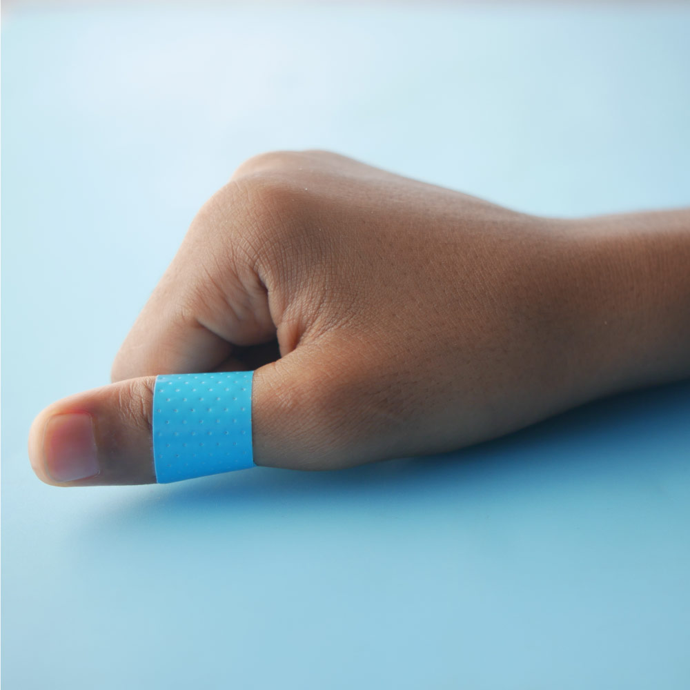food service worker with a blue metal detectable bandage on his finger